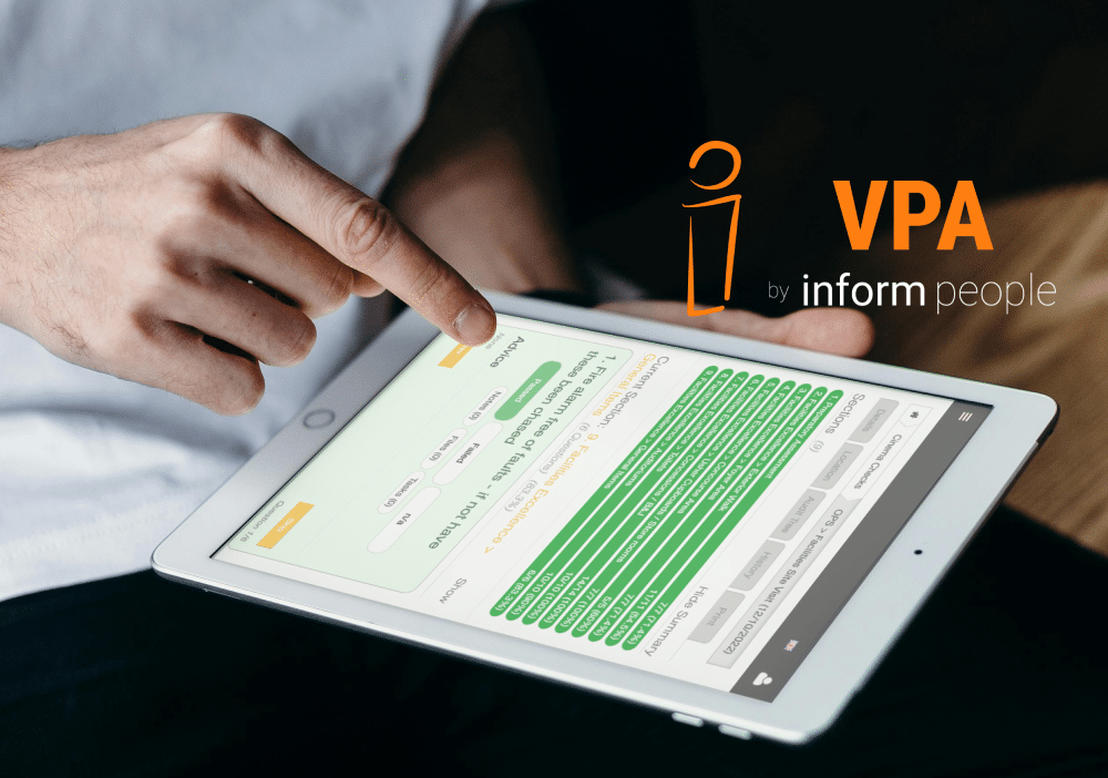 shows hand hovering over tablet that displays a compliance audit on the inform people platform
